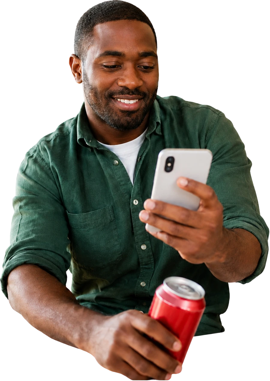A shopper checking a cashback offer on his phone while holding a product